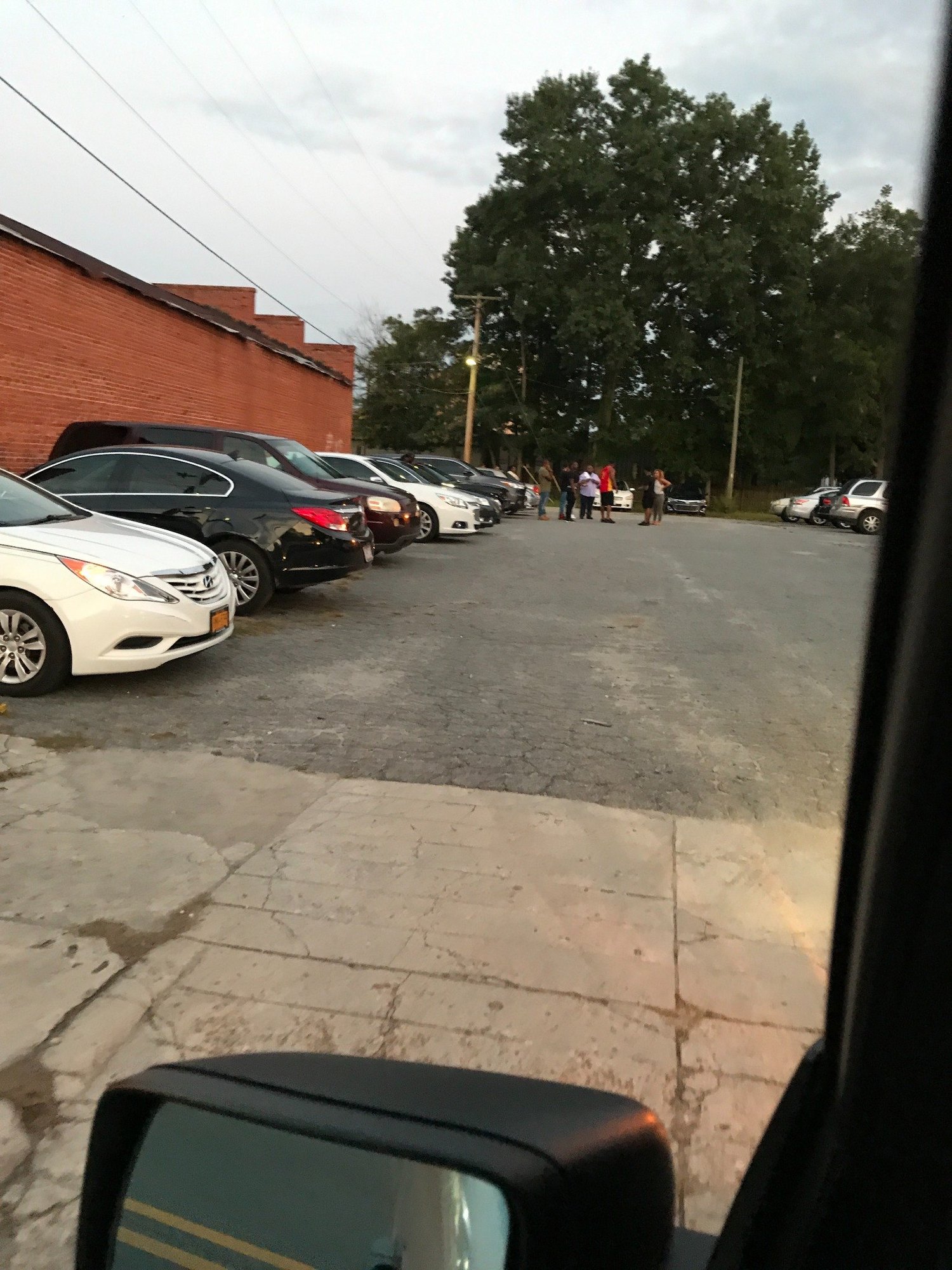 Cars parked along Dennis Street support lot